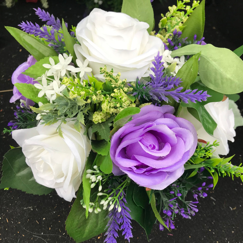 A graveside flower arrangement in black plastic pot AbigailRose