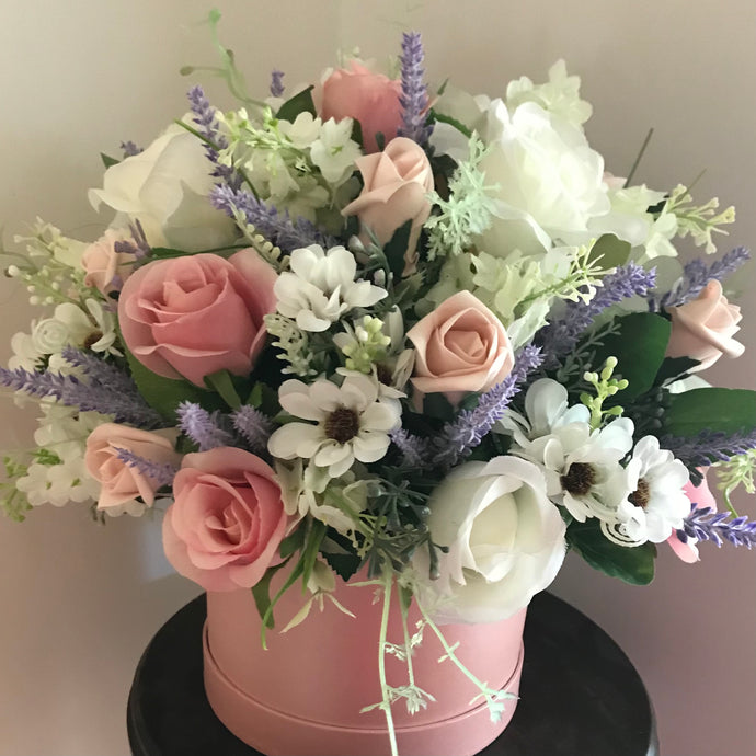 pink and ivory flowers in hat box
