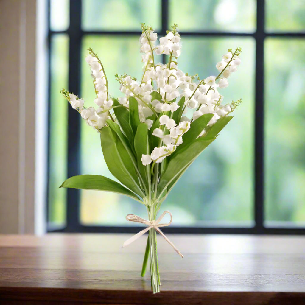 a bunch of 6 artificial lily of the valley flowers and foliage