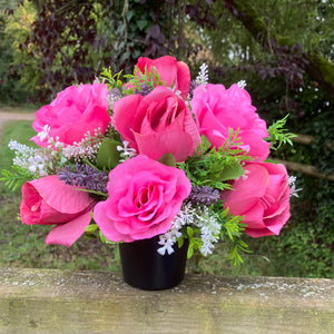 graveside artificial flower arrangement in shades of pink