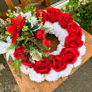 a lge christmas memorial wreath based with carnations and roses