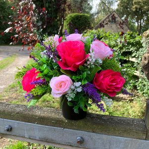 graveside artificial flower arrangement in shades of pink