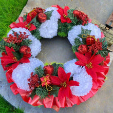 a memorial christmas wreath featuring baubles, cones and poinsettia