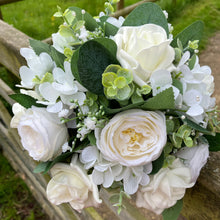A teardrop bouquet collection of ivory roses, hydrangea and eucalyptus