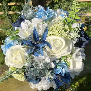 A bridesmaids bouquet of blue & white and ivory silk flowers