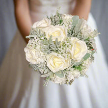 A wedding bouquet collection of ivory artificial silk roses and gyp