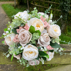 A brides bouquet of pale pink and ivory silk roses & peony flowers