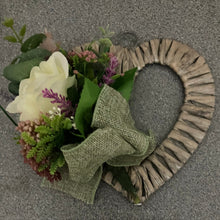 A heart wreath with silk of roses and foliage