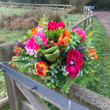 A memorial Flower Arrangement of pink and orange flowers