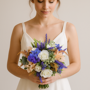 A bridal bouquet of artificial ivory, peach and purple flowers