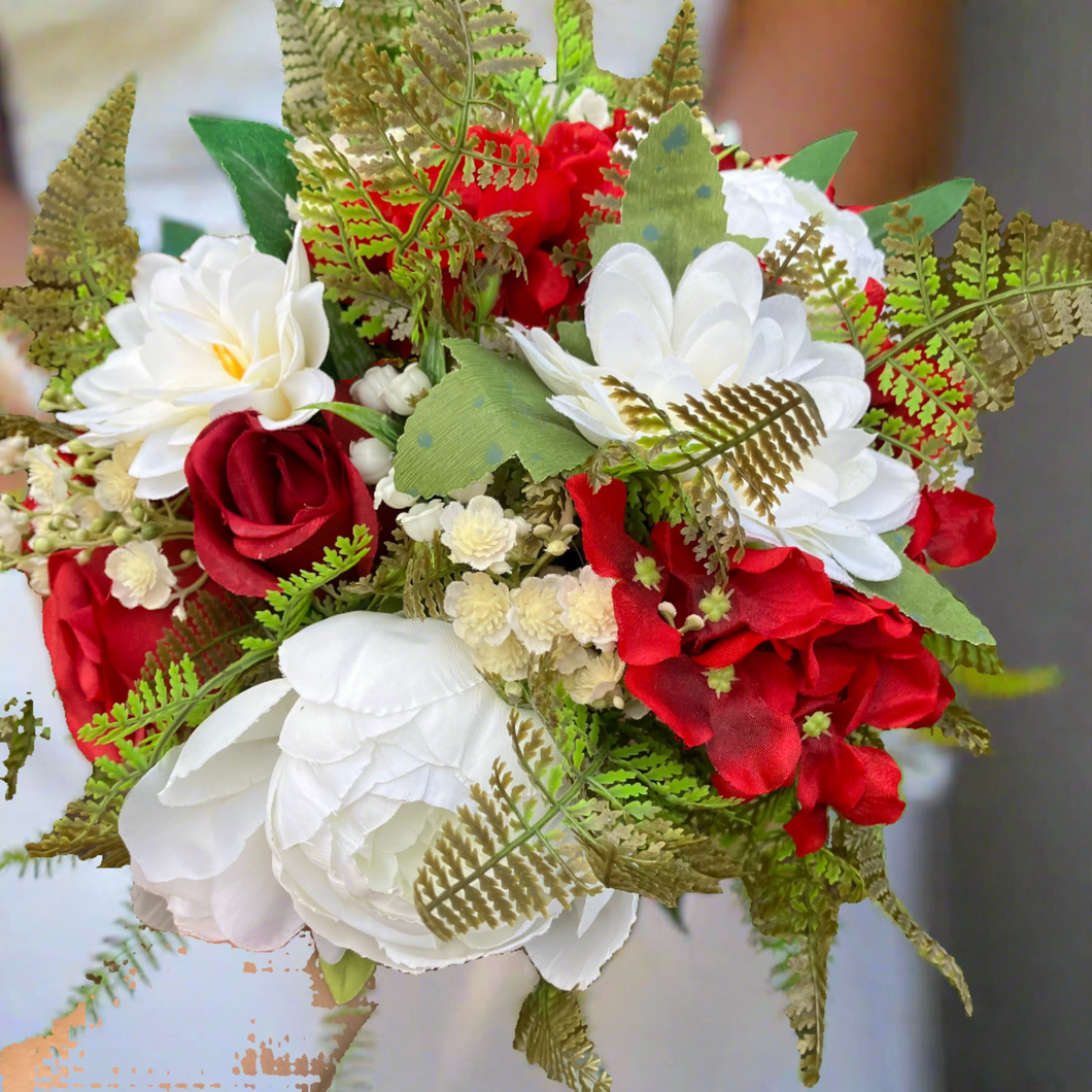 a wedding bouquet featuring silk roses, hydrangea and peonies