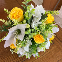 A wedding bouquet collection of yellow and ivory silk flowers