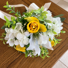 A wedding bouquet collection of yellow and ivory silk flowers