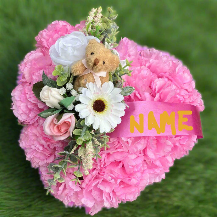 a personalised memorial heart of artificial silk roses and carnations in shades of pink