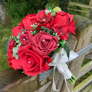 a wedding bouquet of artificial red silk roses & tulip flowers