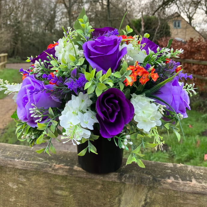 Artificial graveside flowers arrangement in black pot