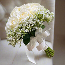 A wedding bouquet of artificial faux silk roses edged with Gypsophila