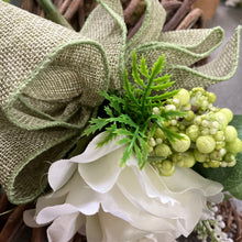 A heart wreath with cluster of flowers and foliage