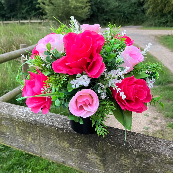 graveside artificial flower arrangement in shades of pink