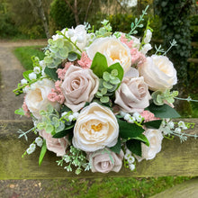 A brides bouquet of pale pink and ivory silk roses & peony flowers