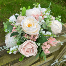 A brides bouquet of pale pink and ivory silk roses & peony flowers