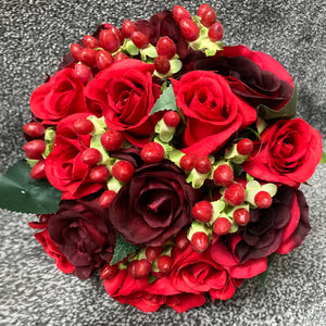 a wedding bouquet of red and burgundy silk roses & hypericum