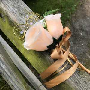 A wedding bouquet featuring silk flowers in shades of ivory and peach