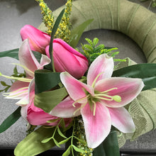 A sage green wreath with silk tulips and lilies
