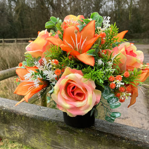 grave pot with faux silk roses and lilies