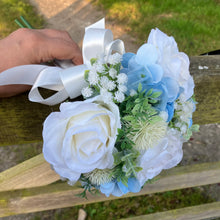 A brides bouquet of white/ivory and pale blue artificial silk flowers