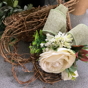 A heart wreath with artificial roses and foliage