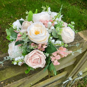 A brides bouquet of pale pink and ivory silk roses & peony flowers