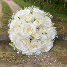 A wedding bouquet of artificial faux silk roses edged with Gypsophila