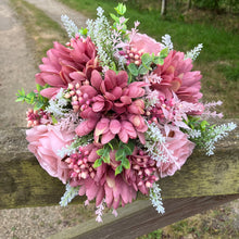 A brides posy featuring artificial pink silk gerbera and roses