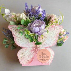 An artificial flower arrangement in butterfly container