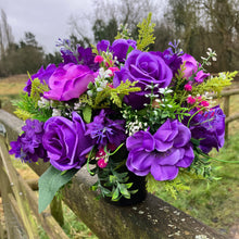 a silk graveside flower arrangement in black pot