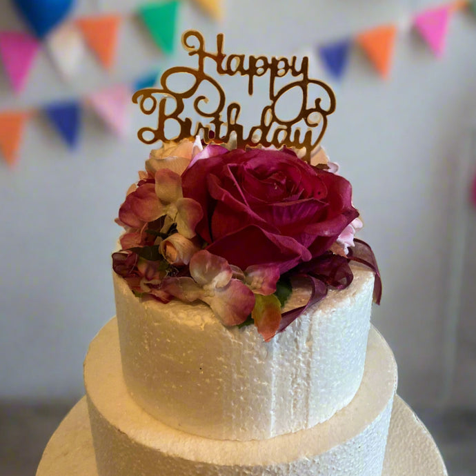 A pink artificial flower cake topper