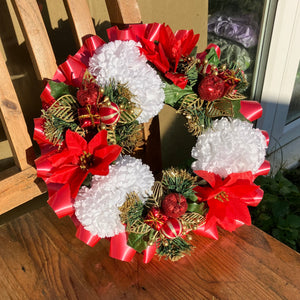 a memorial christmas wreath featuring parcels, carnations & poinsettia