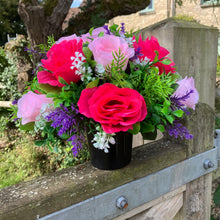 graveside artificial flower arrangement in shades of pink