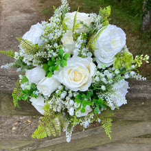 A wedding bouquet collection of white artificial silk roses peonies and gyp
