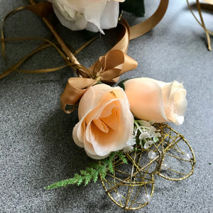 A wedding bouquet featuring silk flowers in shades of ivory and peach