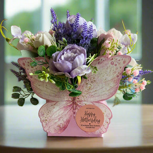 An artificial flower arrangement in butterfly container