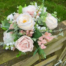 A brides bouquet of pale pink and ivory silk roses & peony flowers