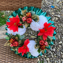 a memorial christmas wreath featuring baubles, cones and poinsettia