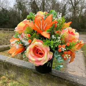 grave pot with faux silk roses and lilies