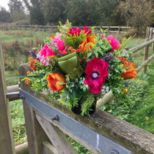 A memorial Flower Arrangement of pink and orange flowers