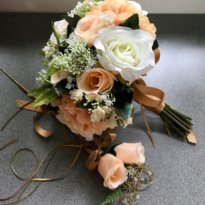 A wedding bouquet featuring silk flowers in shades of ivory and peach