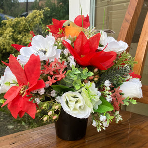 An artificial graveside flower arrangement in pot