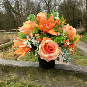 grave pot with faux silk roses and lilies