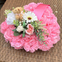 a personalised memorial heart of artificial silk roses and carnations in shades of pink